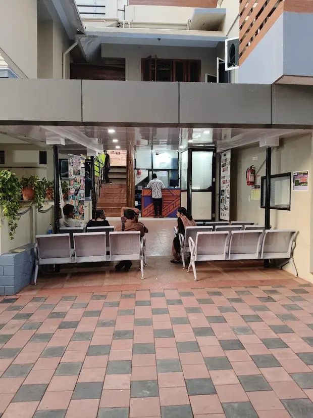 Entrance and covered waiting area at Pratheep Nursing Home with the reception counter beyond