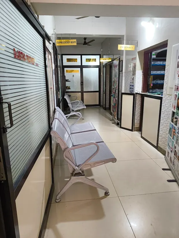 Corridor at Pratheep Nursing Home signposted for the consultation room, operation theatre, ICU and pharmacy