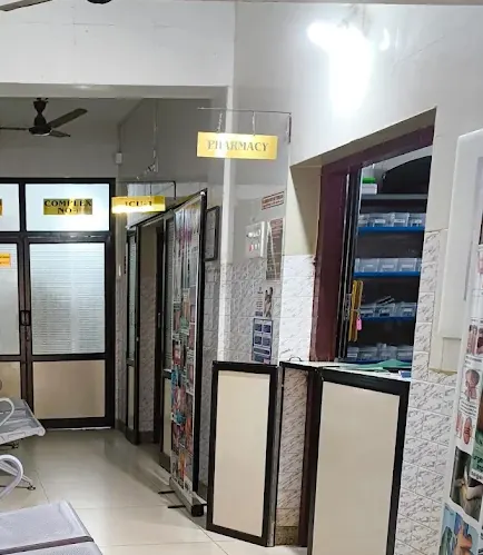 Pharmacy counter inside Pratheep Nursing Home with stocked medicine shelves